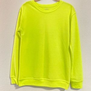 City streets woman’s neon yellow workout sweater